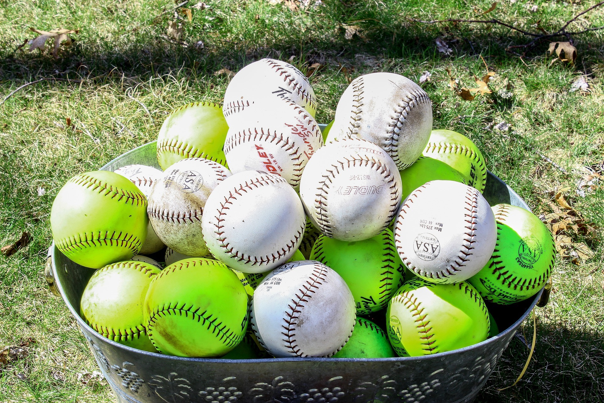 Bin full of softballs and baseballs