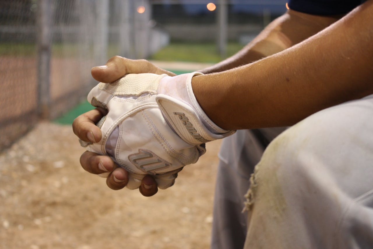 Man in White Gloves Sitting during Nighttime